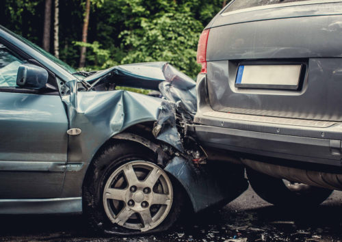 Close up smached cars on a road.